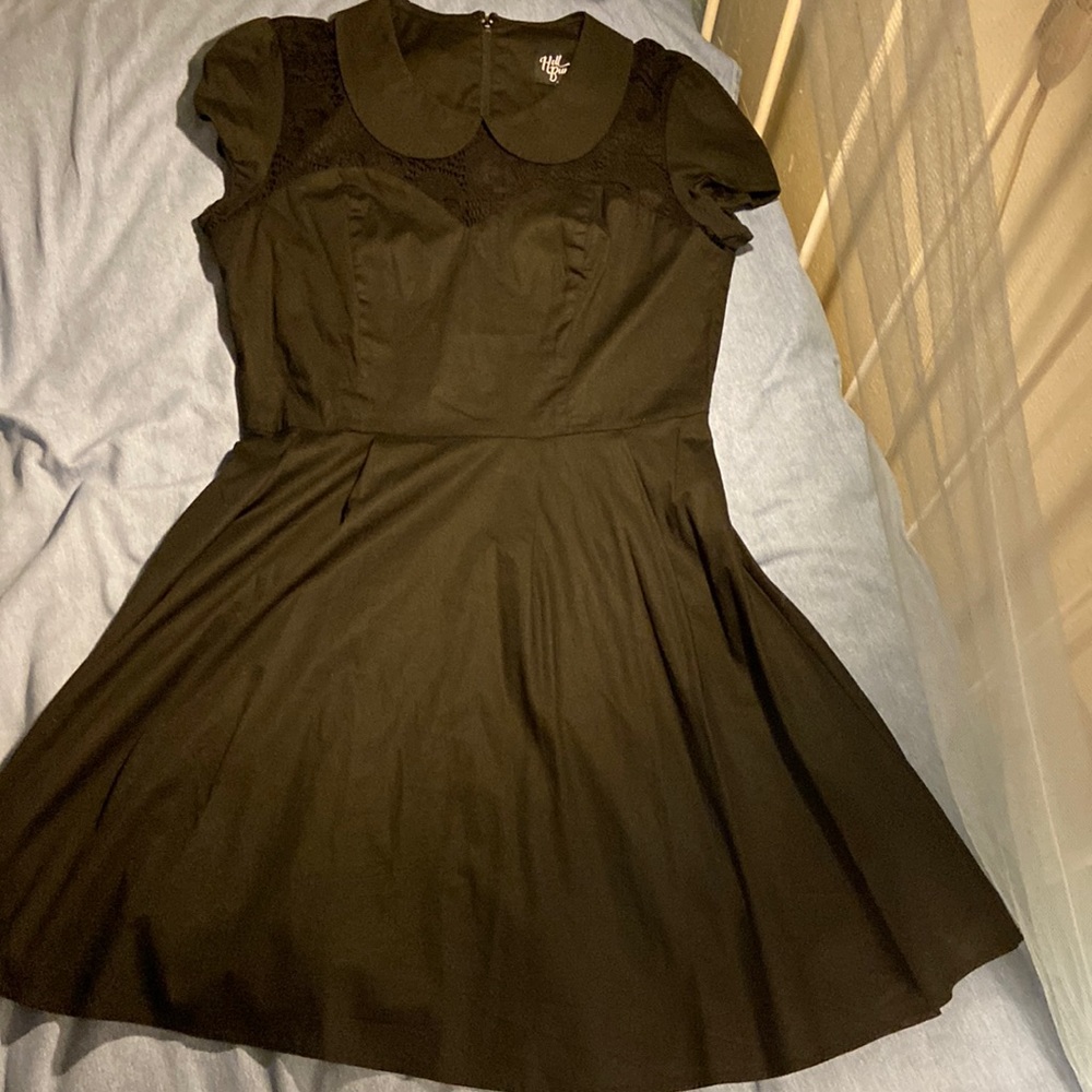 Retro style black cocktail dress with skulls and cutaway